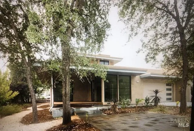 a front view of a house with garden