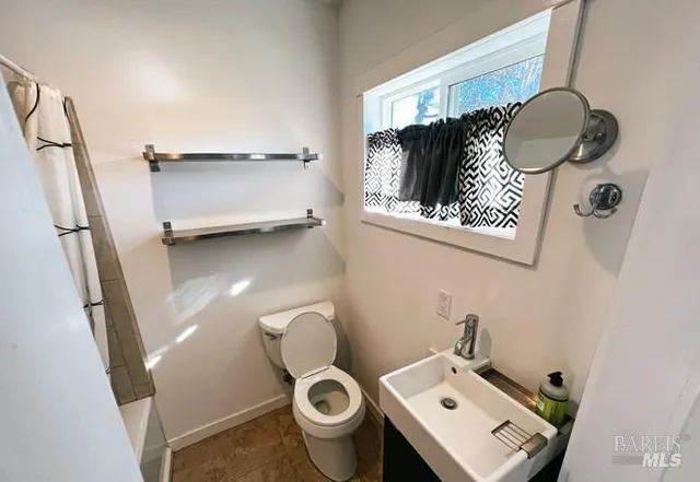 a bathroom with a toilet and a sink