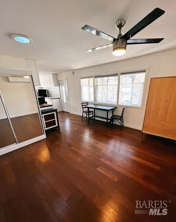 a view of a room with wooden floor and furniture