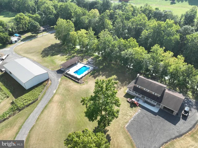 an aerial view of a house with a yard and lake view