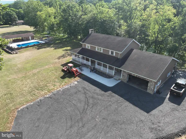 a view of a house with pool and yard