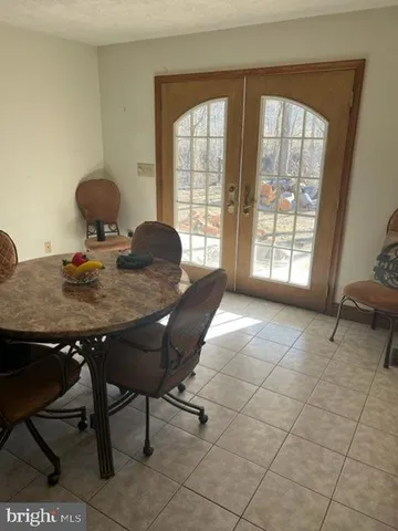 a bed sitting in a spacious bedroom next to a window