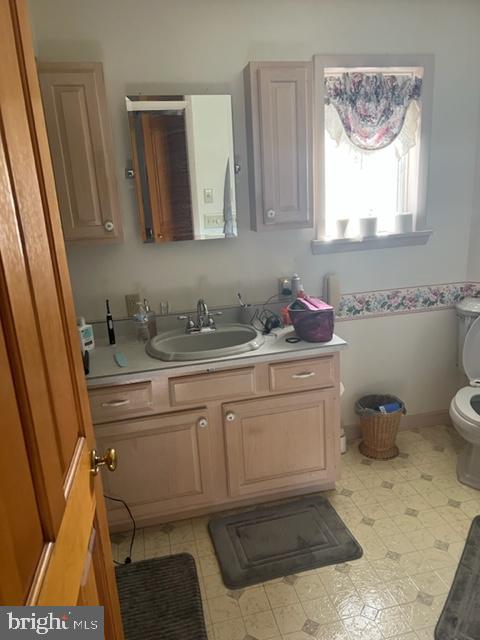 13900 Schellsburg Road Ellerslie, MD 21529 - Photo 40 of 59 a bathroom with a sink toilet and mirror