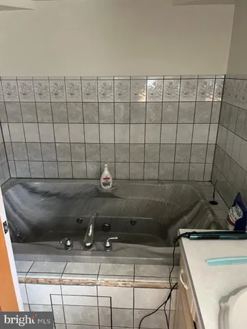 a room with pool table and chairs