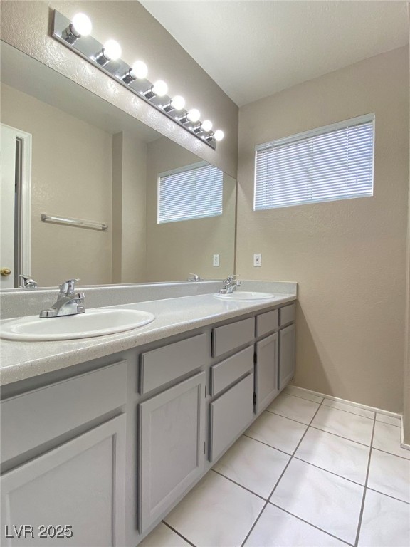 1425 Spice Sky Drive Las Vegas, NV 89128 - Photo 12 of 16 Bathroom featuring light tile patterned floors and double vanity