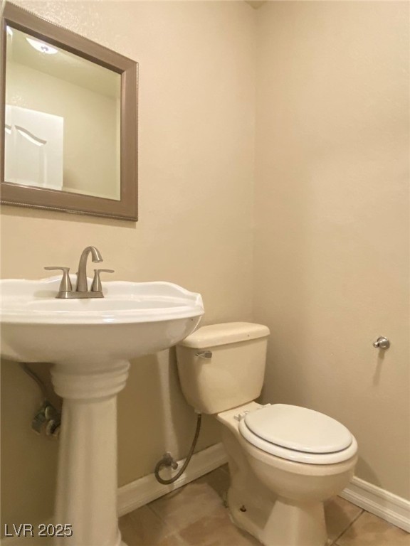 1425 Spice Sky Drive Las Vegas, NV 89128 - Photo 8 of 16 Half bathroom featuring toilet and light tile patterned flooring