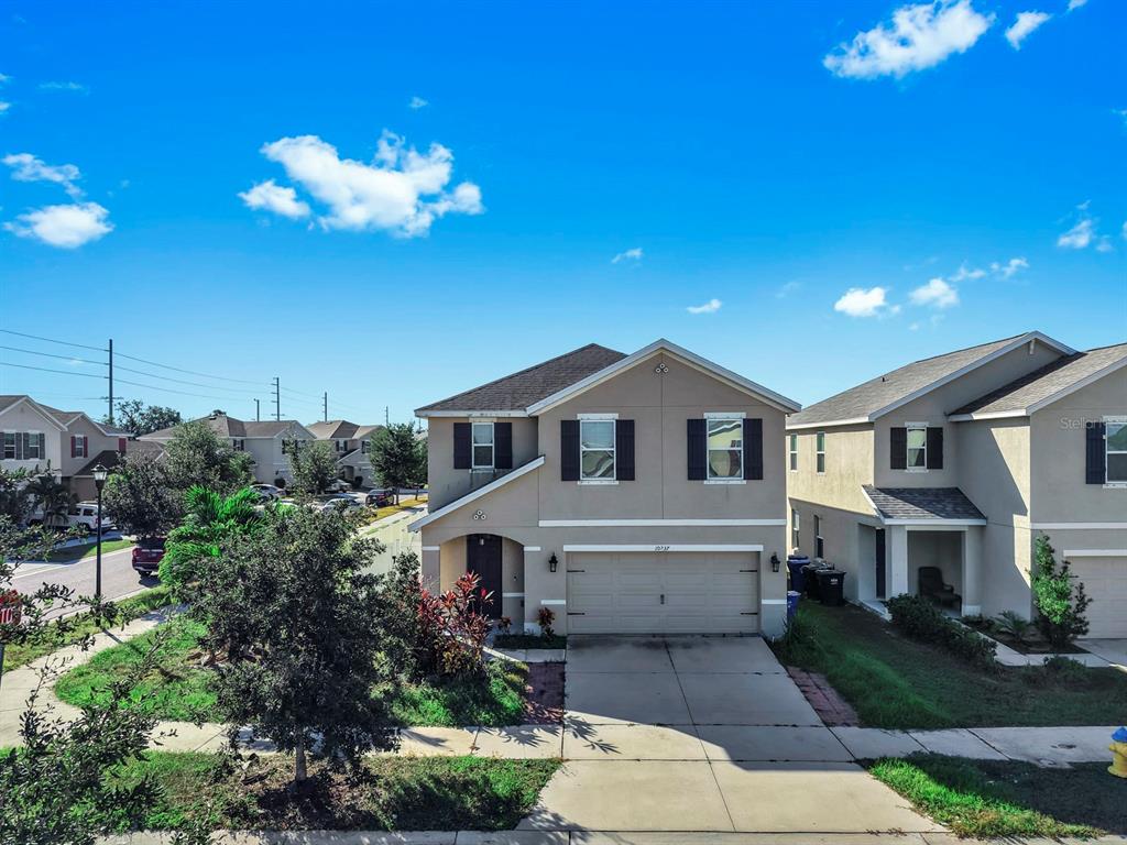 10237 Mangrove Well Road Sun City Center, FL 33573 - Photo 3 of 56 a front view of a house with a yard
