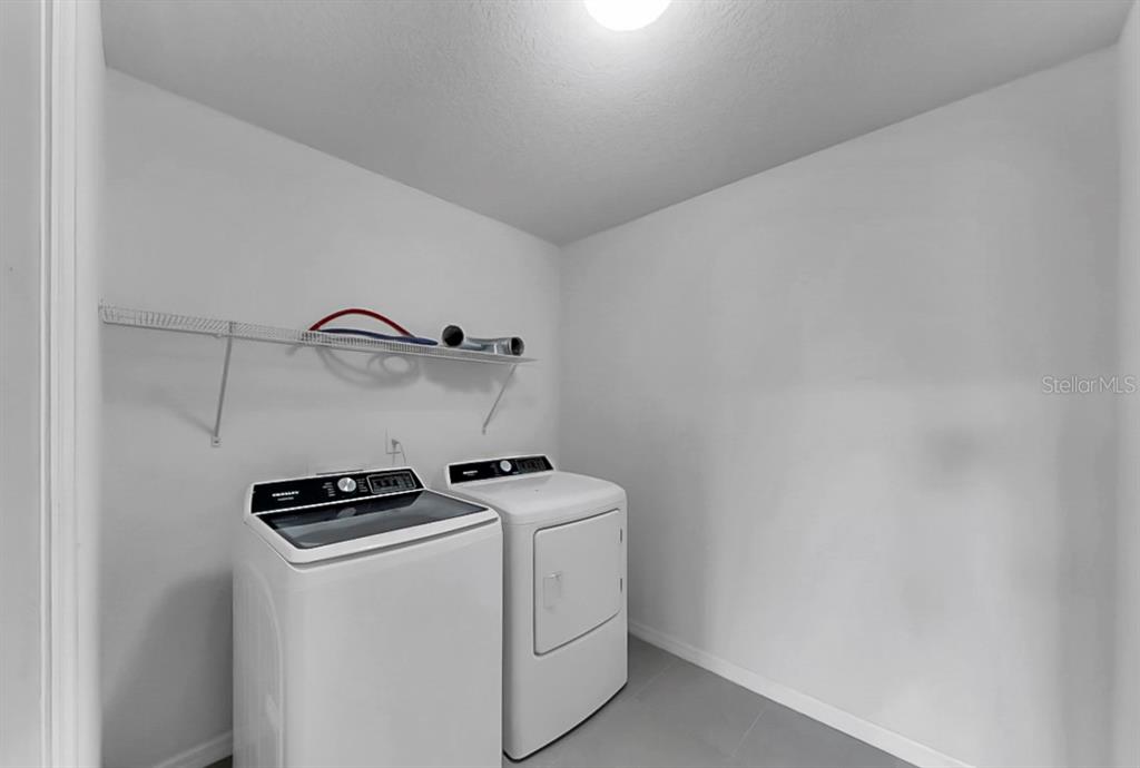 10237 Mangrove Well Road Sun City Center, FL 33573 - Photo 33 of 56 a utility room with dryer and washer