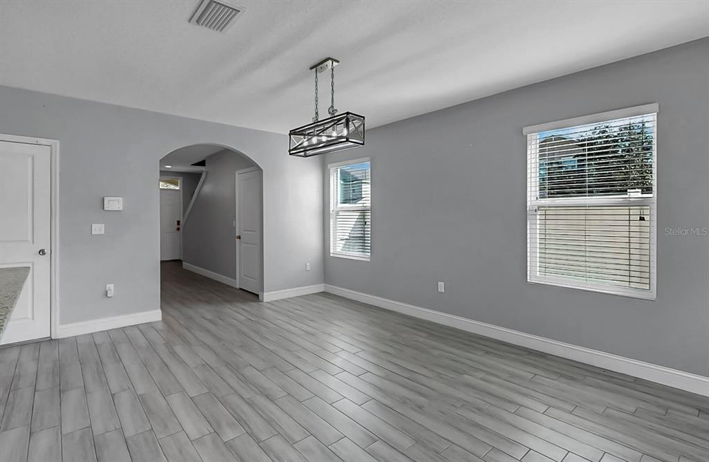 10237 Mangrove Well Road Sun City Center, FL 33573 - Photo 8 of 56 a view of empty room with wooden floor and window
