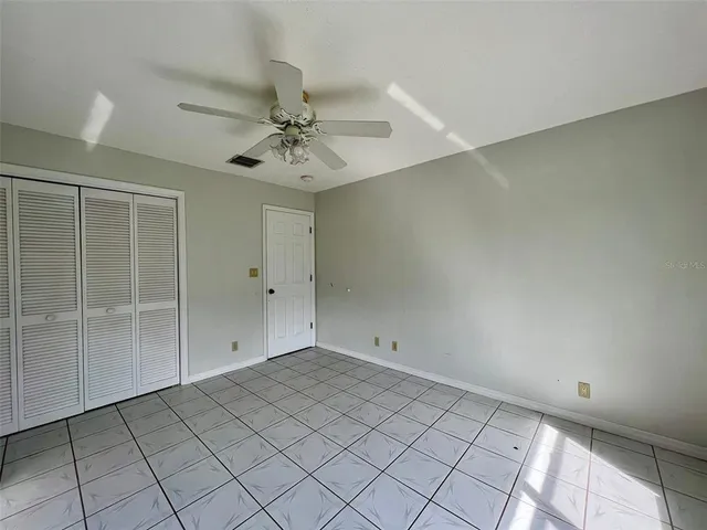 a view of a house with a yard and potted plants