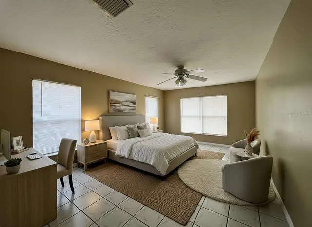 a living room with a bed furniture and a window