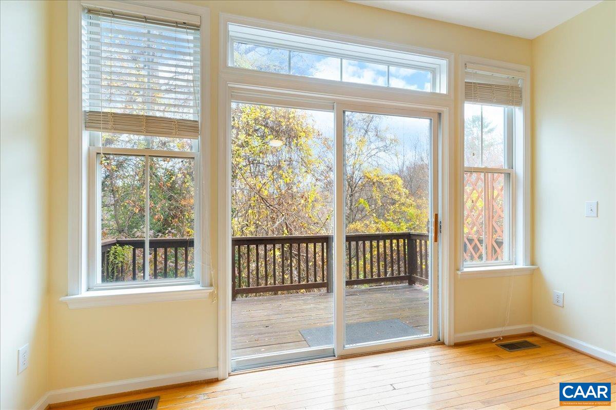 104 Melbourne Park Circle, Unit E Charlottesville, VA 22901 - Photo 11 of 33 a view of a room with wooden floor and a window