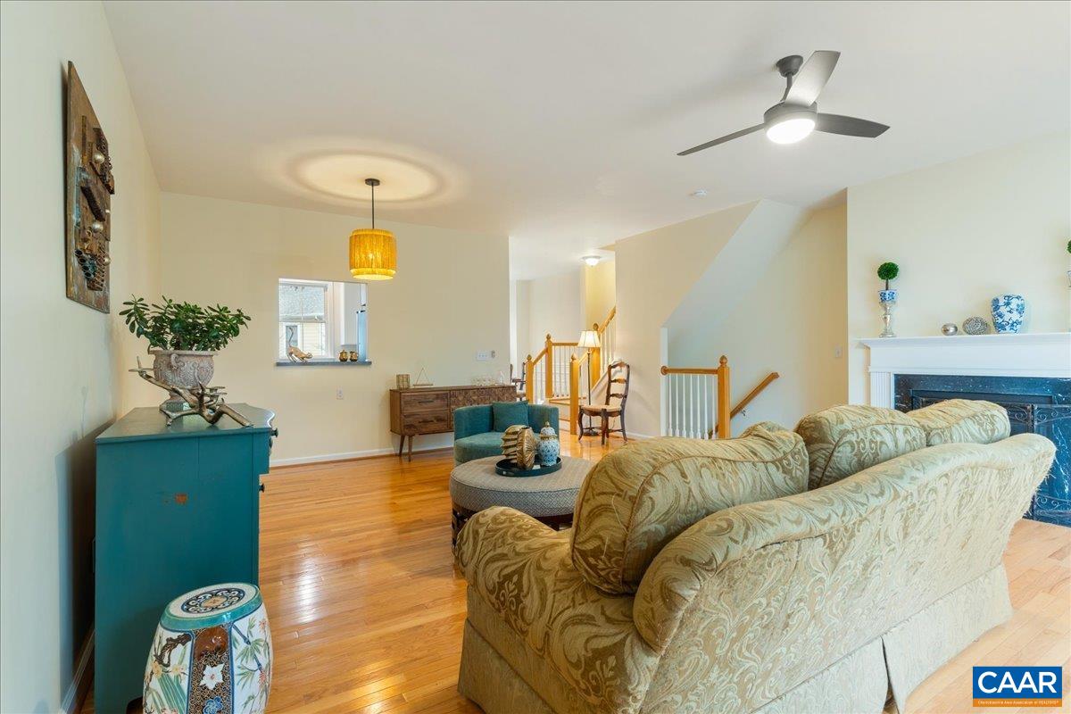 104 Melbourne Park Circle, Unit E Charlottesville, VA 22901 - Photo 13 of 33 a living room with furniture and a chandelier