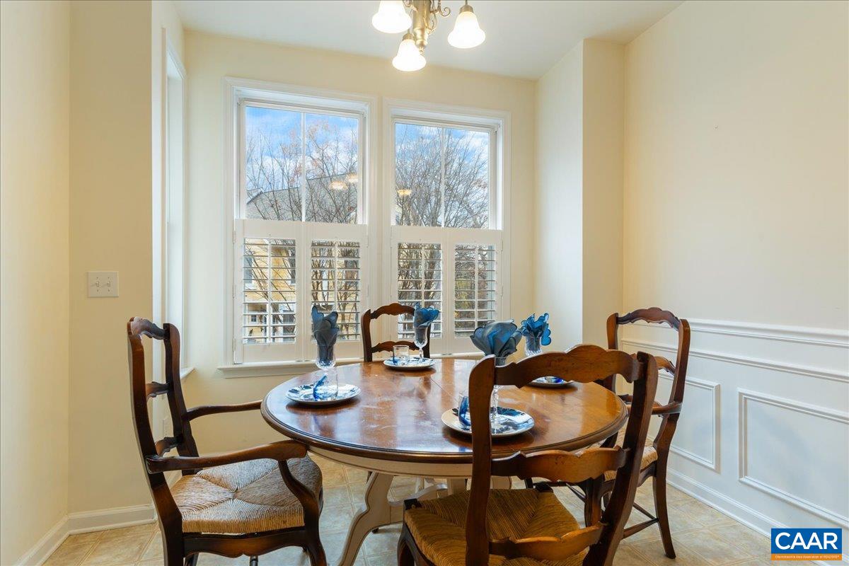 104 Melbourne Park Circle, Unit E Charlottesville, VA 22901 - Photo 16 of 33 a view of a dining room with furniture and window