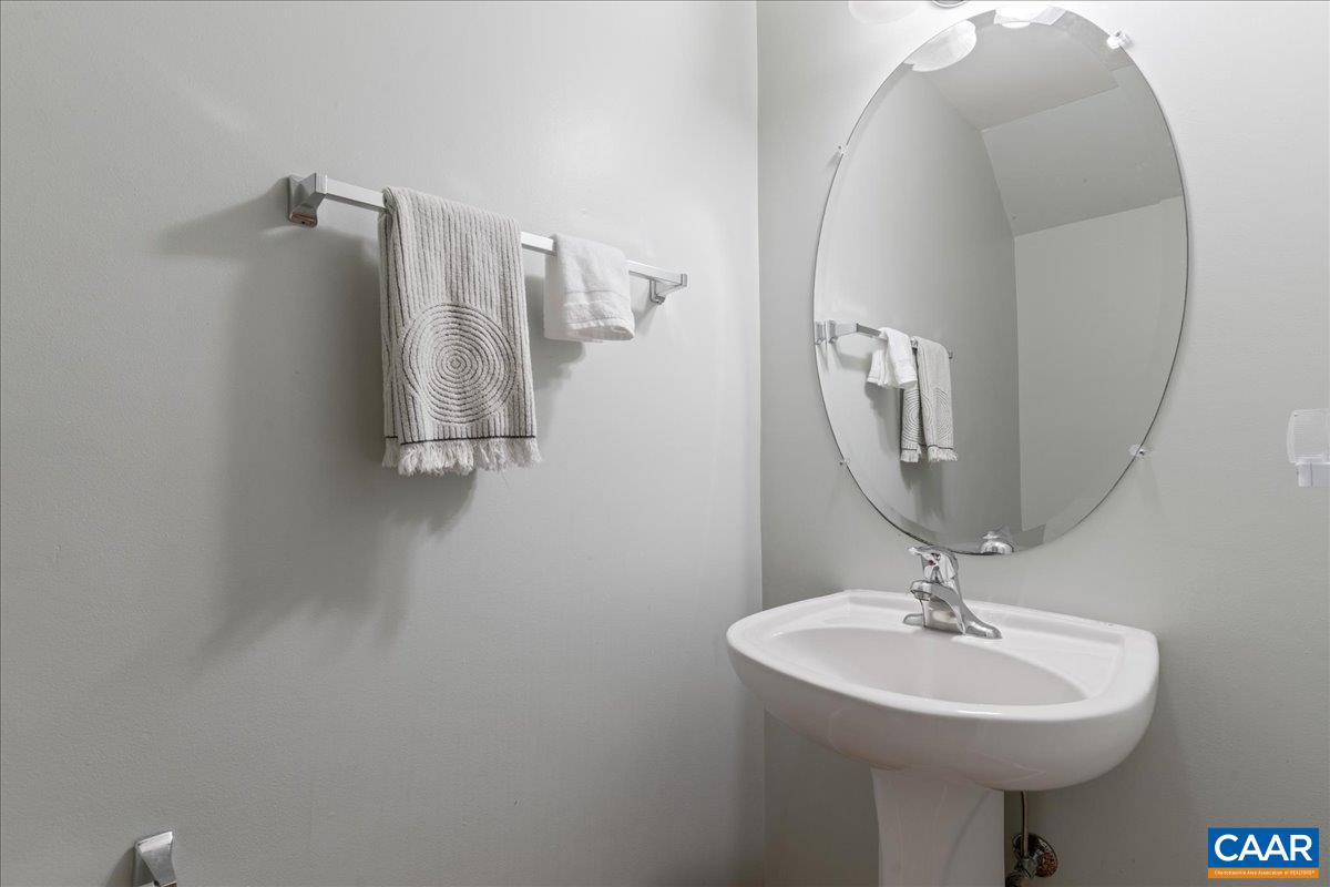 104 Melbourne Park Circle, Unit E Charlottesville, VA 22901 - Photo 32 of 33 a bathroom with a sink a mirror and vanity