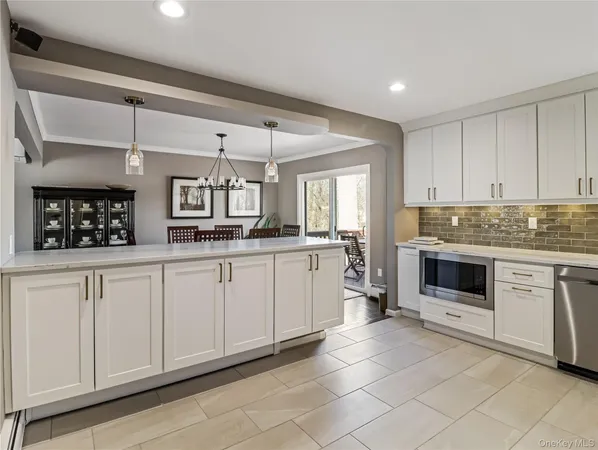 a kitchen with stainless steel appliances a refrigerator and a stove top oven