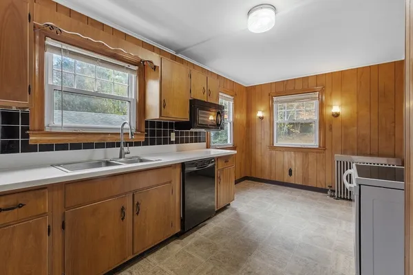 a kitchen with sink cabinets and window