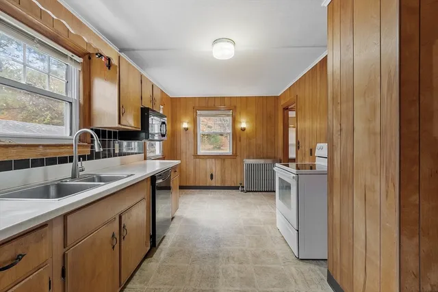 a kitchen with a sink and a refrigerator