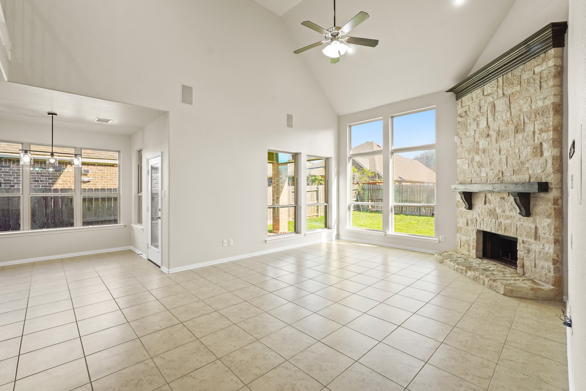 10335 Belvamera Road Richmond, TX 77407 - Photo 12 of 27 a view of an empty room with a fireplace and a large window
