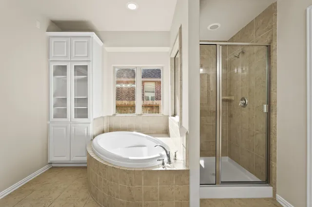 a bathroom with a bathtub and shower