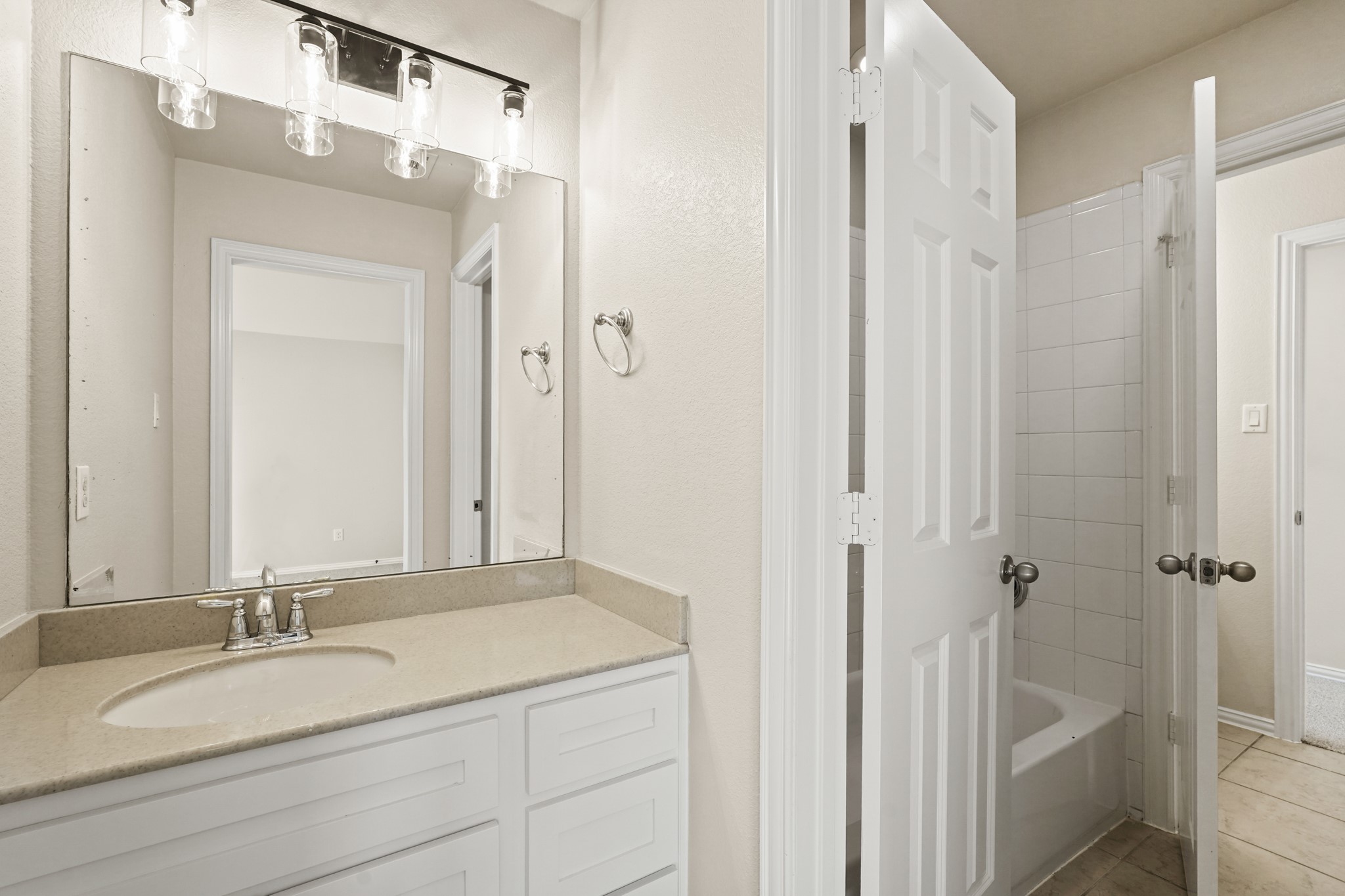 10335 Belvamera Road Richmond, TX 77407 - Photo 25 of 27 a bathroom with a granite countertop sink and a mirror