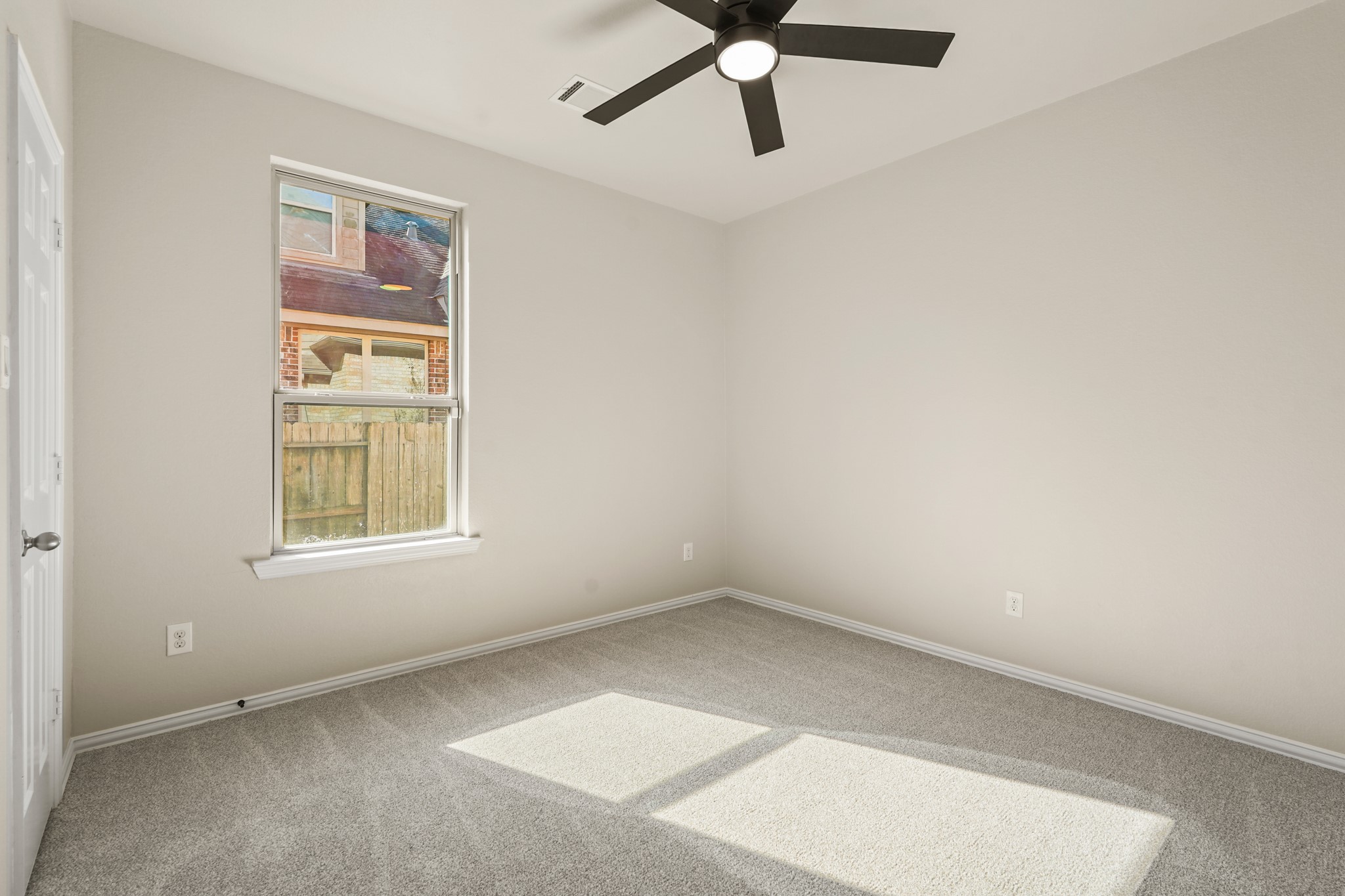 10335 Belvamera Road Richmond, TX 77407 - Photo 5 of 27 an empty room with a window and a ceiling fan