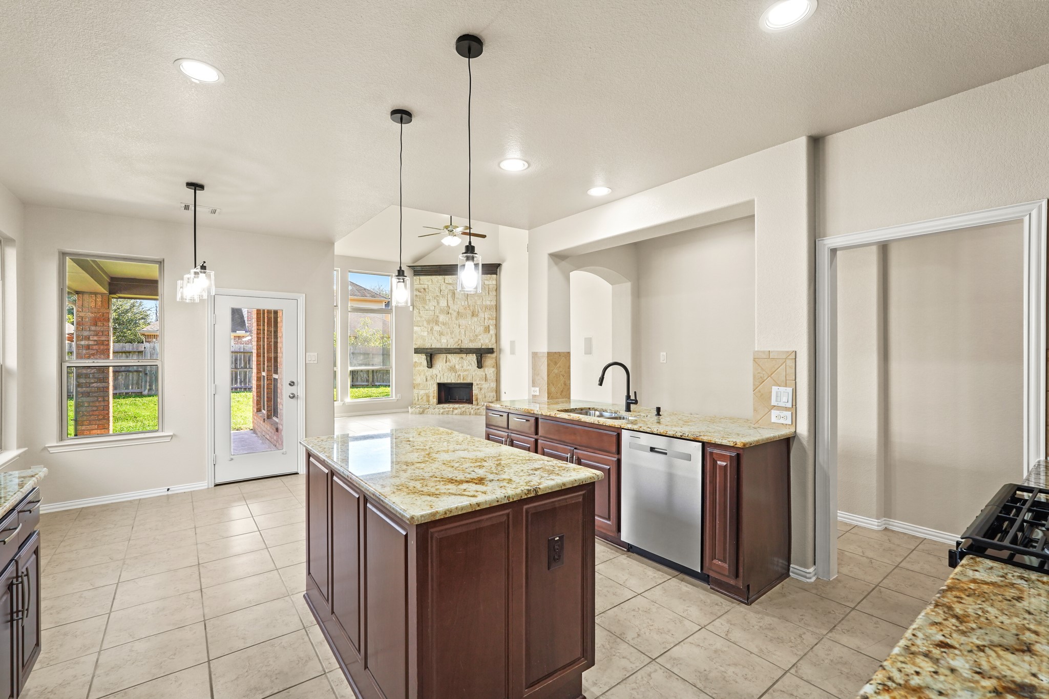 10335 Belvamera Road Richmond, TX 77407 - Photo 8 of 27 a kitchen with stainless steel appliances granite countertop a sink and a refrigerator