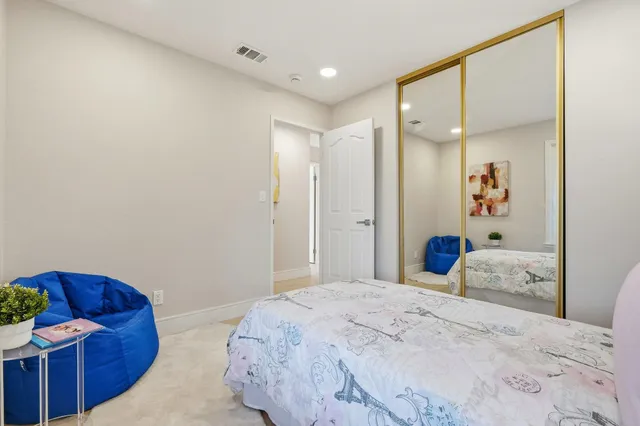 a bedroom with a bed and gym equipment