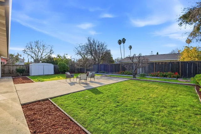 a swimming pool with outdoor seating and yard