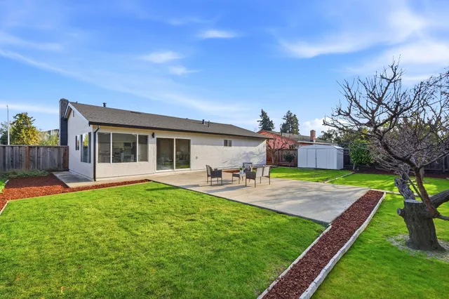 a house view with a sitting space and garden