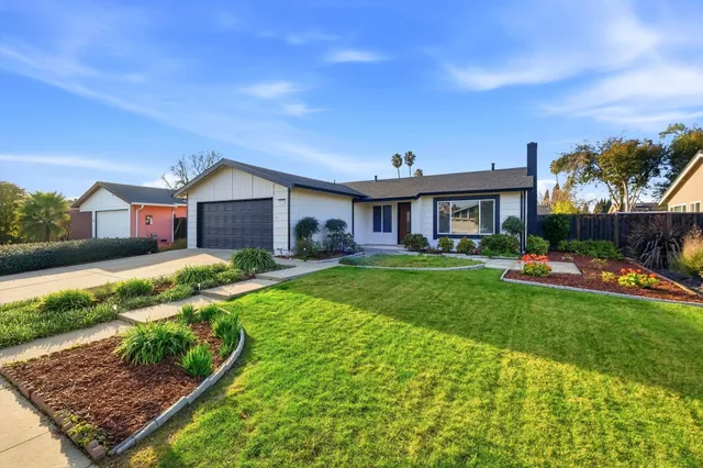 a view of an house with backyard space and balcony