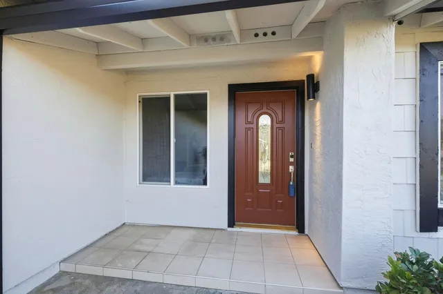a view of a hallway with wooden shelves