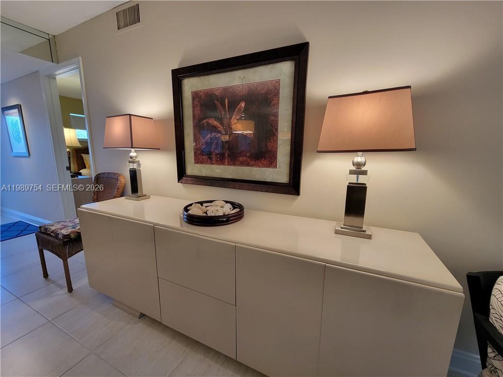 3774 Inverrary Boulevard, Unit 103P Lauderhill, FL 33319 - Photo 11 of 35 a living room with furniture and a flat screen tv