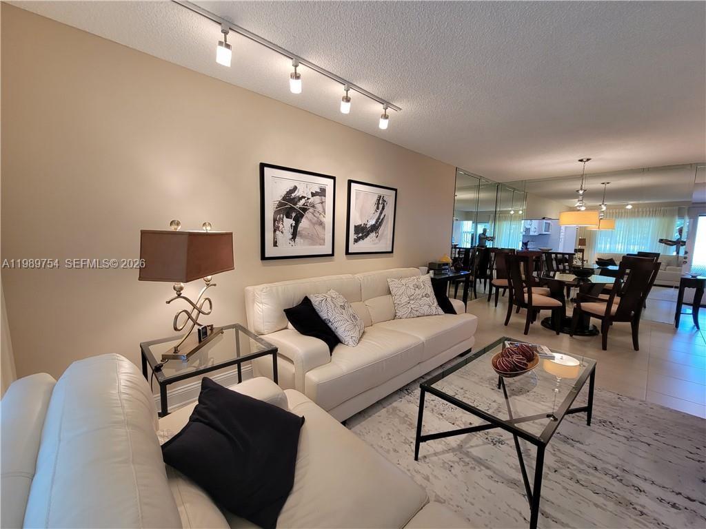 3774 Inverrary Boulevard, Unit 103P Lauderhill, FL 33319 - Photo 14 of 35 a living room with furniture