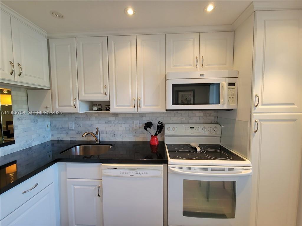 3774 Inverrary Boulevard, Unit 103P Lauderhill, FL 33319 - Photo 18 of 35 a kitchen with appliances a sink and cabinets