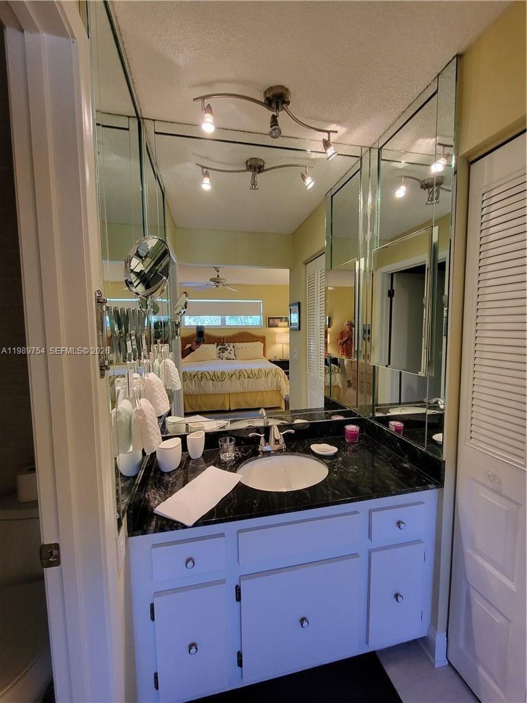 3774 Inverrary Boulevard, Unit 103P Lauderhill, FL 33319 - Photo 20 of 35 a bathroom with a sink and a mirror
