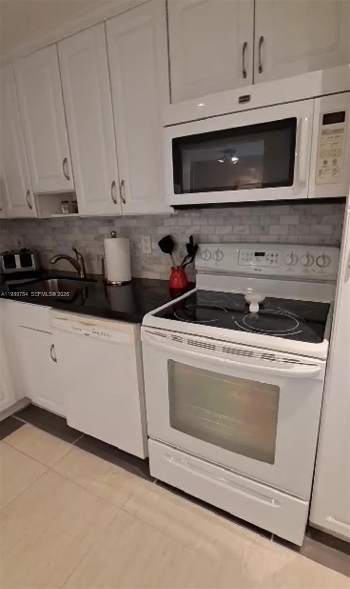 3774 Inverrary Boulevard, Unit 103P Lauderhill, FL 33319 - Photo 2 of 35 a kitchen with microwave cabinets and stainless steel appliances