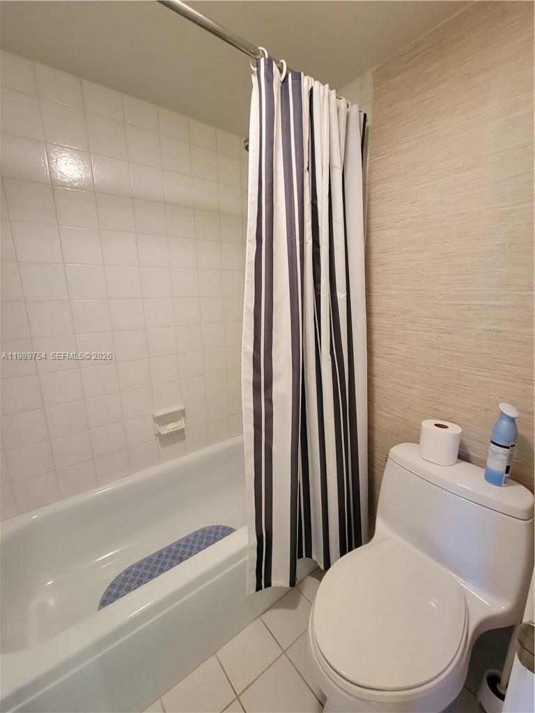 3774 Inverrary Boulevard, Unit 103P Lauderhill, FL 33319 - Photo 21 of 35 a white toilet sitting next to a bathroom sink and tub