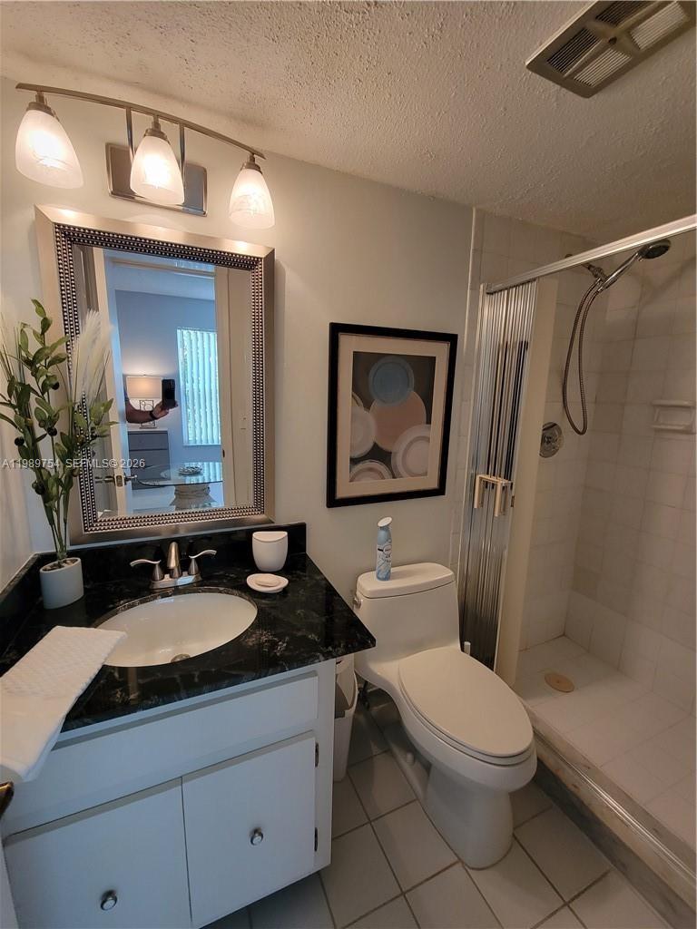 3774 Inverrary Boulevard, Unit 103P Lauderhill, FL 33319 - Photo 26 of 35 a bathroom with a toilet a sink and mirror