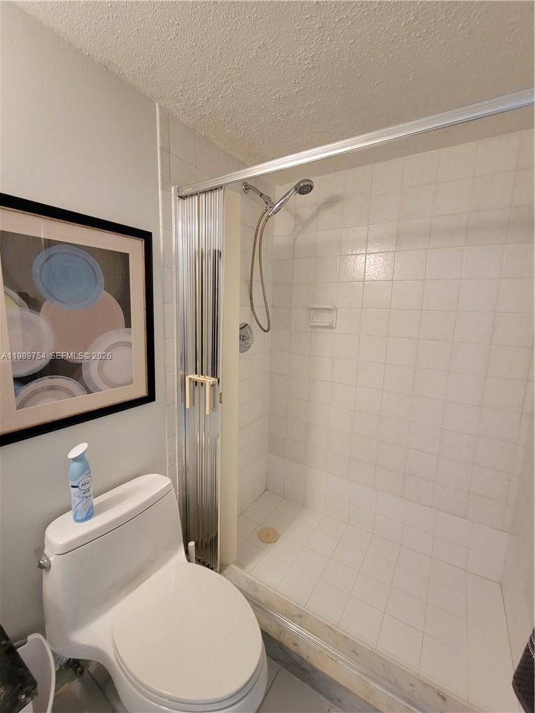 3774 Inverrary Boulevard, Unit 103P Lauderhill, FL 33319 - Photo 27 of 35 a white toilet and shower next to a shower