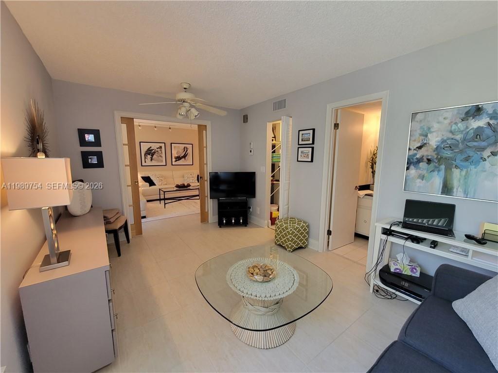 3774 Inverrary Boulevard, Unit 103P Lauderhill, FL 33319 - Photo 29 of 35 a room with furniture and a flat screen tv