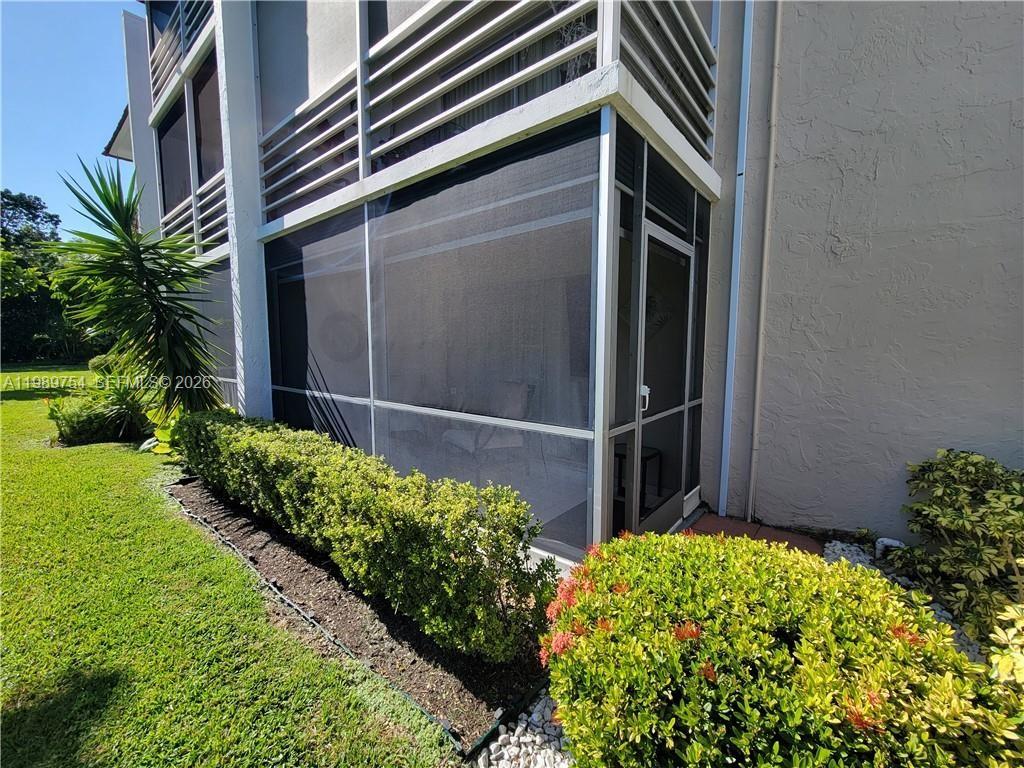 3774 Inverrary Boulevard, Unit 103P Lauderhill, FL 33319 - Photo 35 of 35 a view of a house with a yard and flower plants