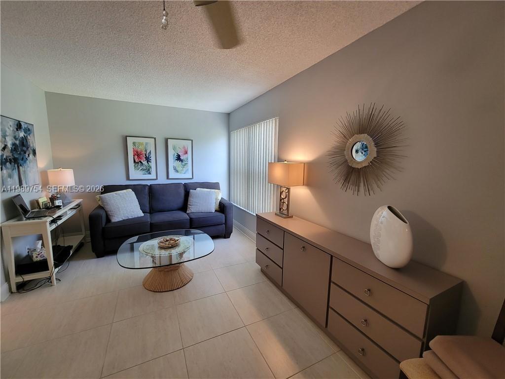 3774 Inverrary Boulevard, Unit 103P Lauderhill, FL 33319 - Photo 5 of 35 a living room with furniture and a window