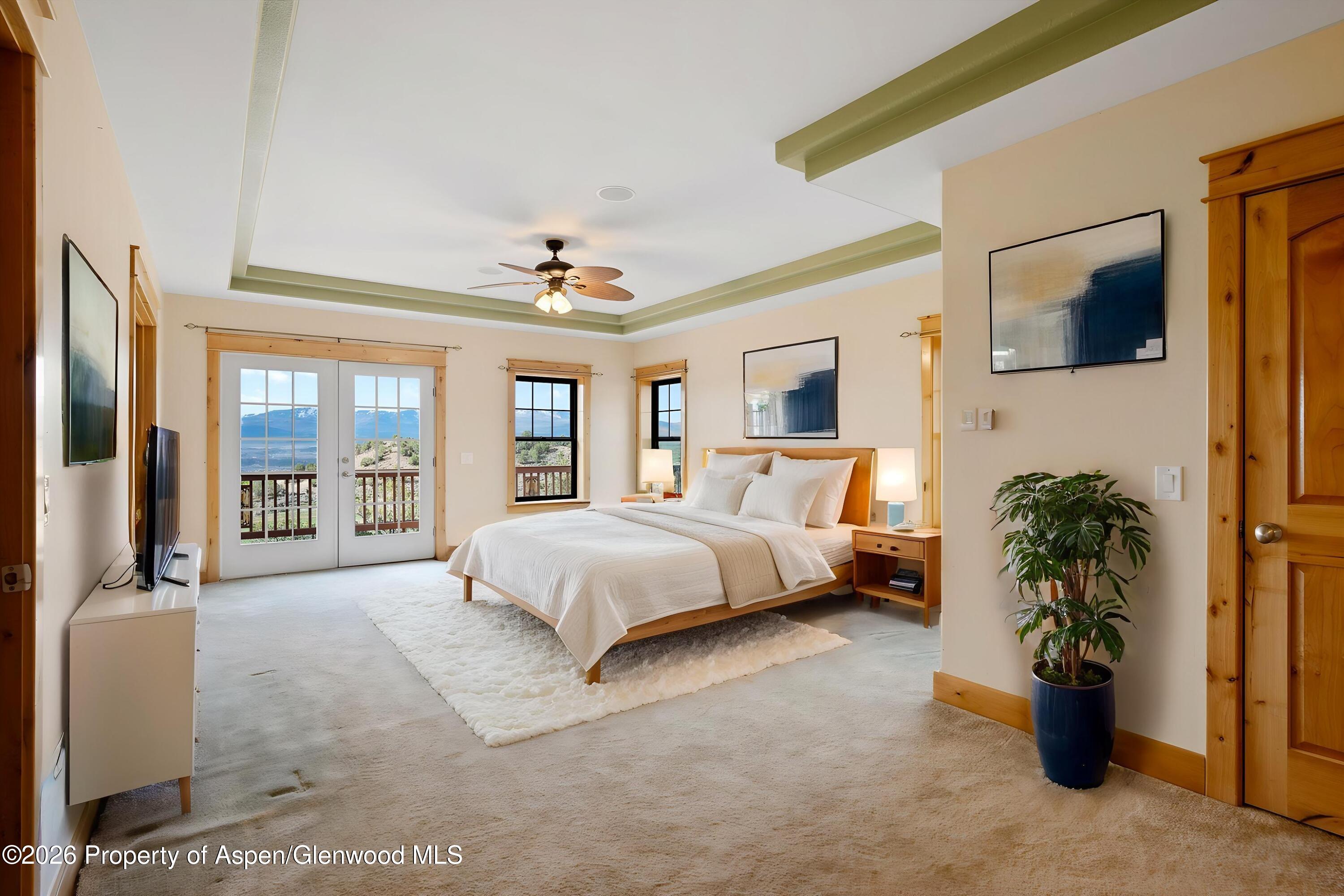 450 Summer Falls Road Silt, CO 81652 - Photo 6 of 50 a spacious bedroom with a large bed and a large window