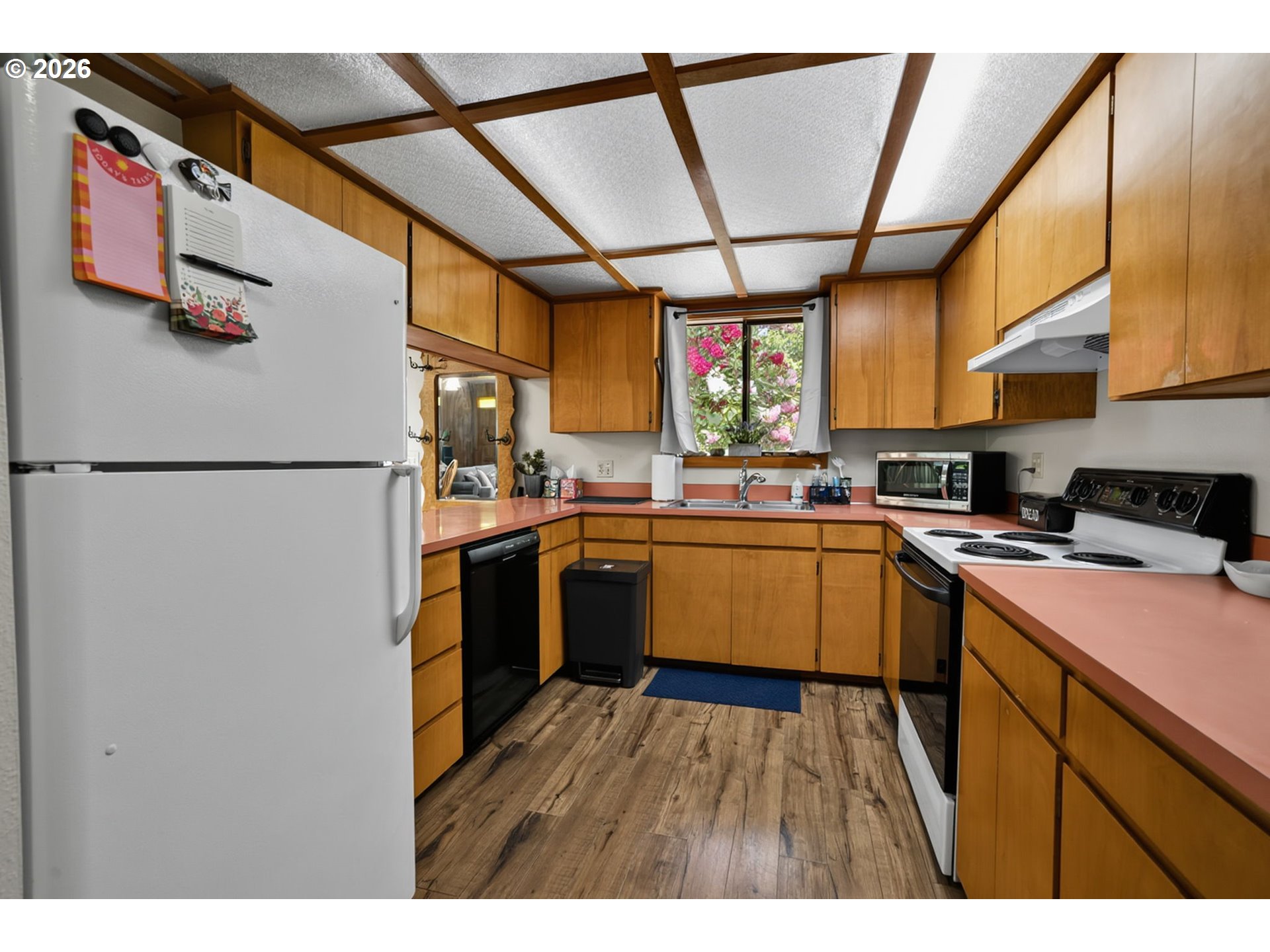 46725 Goodpasture Road Vida, OR 97488 - Photo 33 of 48 a kitchen with stainless steel appliances granite countertop a refrigerator a sink dishwasher a stove with wooden floor
