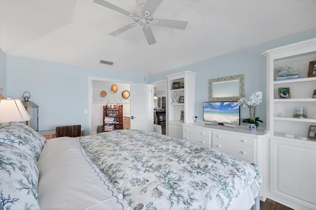 5854 Gasparilla Road, Unit MV20 Boca Grande, FL 33921 - Photo 13 of 49 a bedroom with a large bed and a flat tv screen on dresser