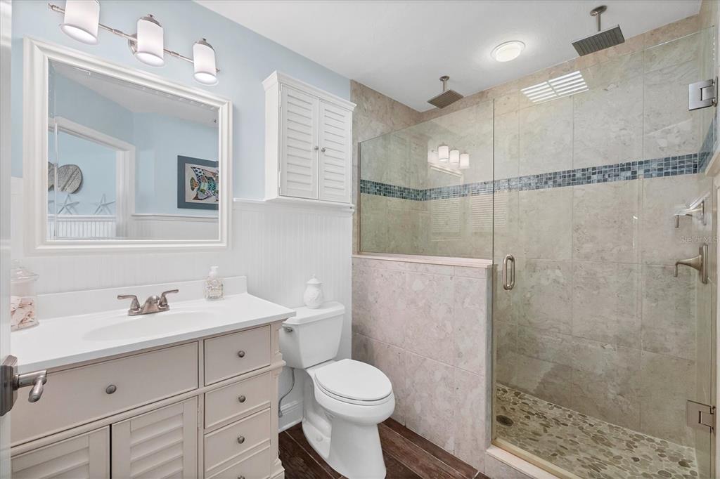 5854 Gasparilla Road, Unit MV20 Boca Grande, FL 33921 - Photo 15 of 49 a bathroom with a sink toilet a mirror and shower