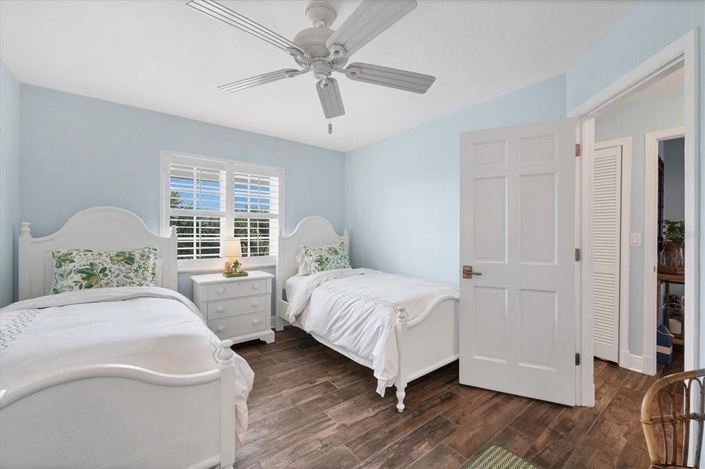 5854 Gasparilla Road, Unit MV20 Boca Grande, FL 33921 - Photo 17 of 49 a bedroom with two beds and a chandelier