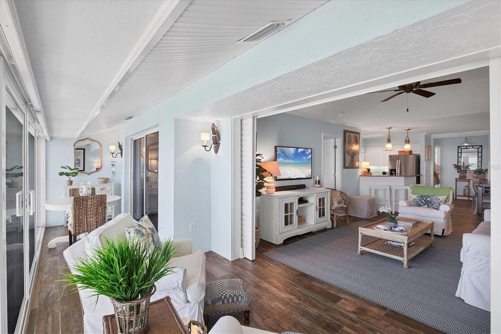 5854 Gasparilla Road, Unit MV20 Boca Grande, FL 33921 - Photo 20 of 49 a living room with furniture and a dining table with wooden floor