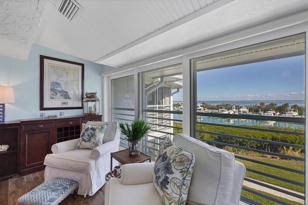 5854 Gasparilla Road, Unit MV20 Boca Grande, FL 33921 - Photo 21 of 49 a living room with furniture floor to ceiling window next to a yard